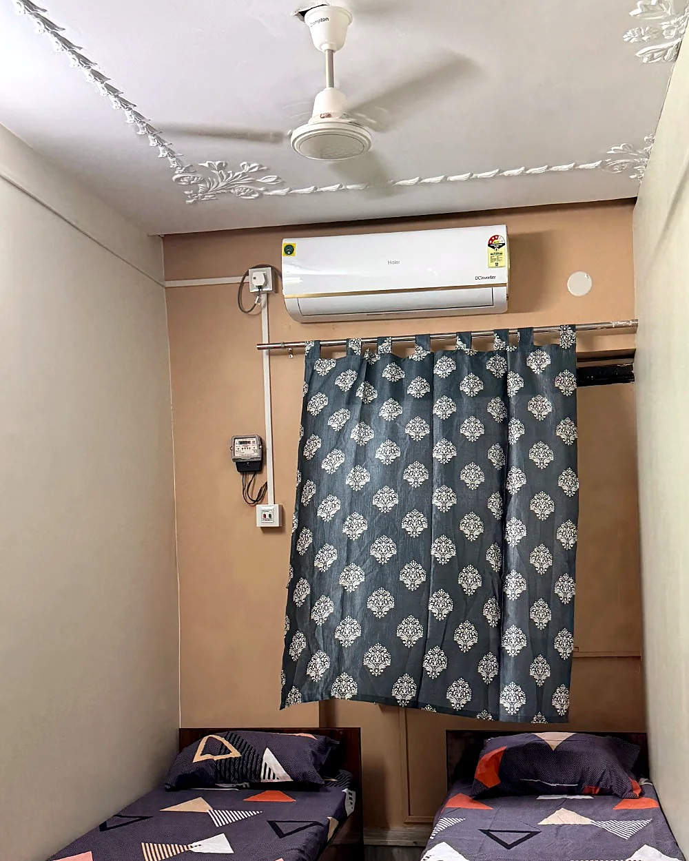 Compact twin-sharing room with air conditioning and two individual beds